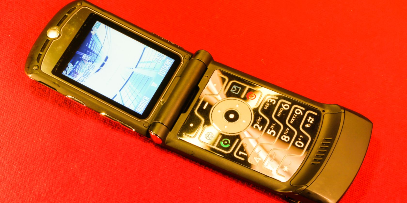 A motorola Razr phone on a red background