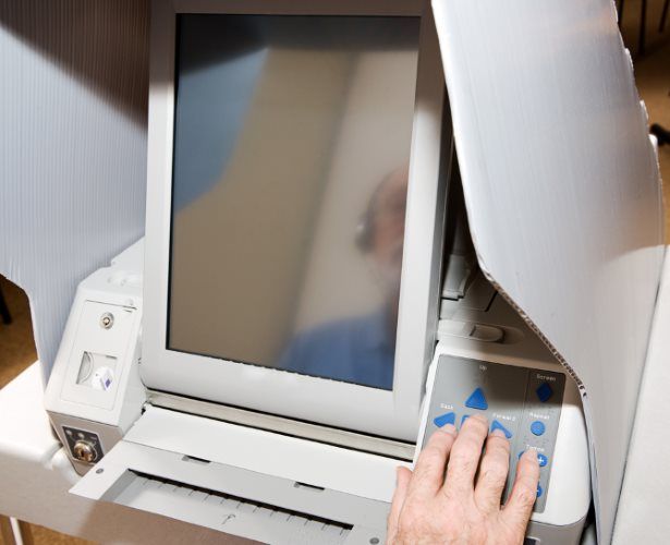 Someone using an electronic voting machine